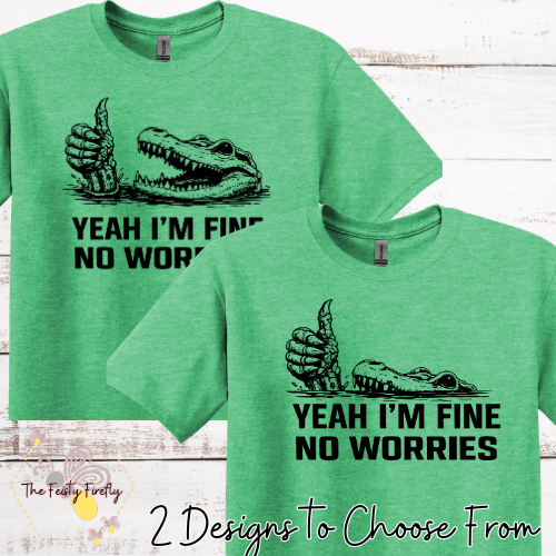 Green t-shirt with alligator graphic and text on a wooden surface